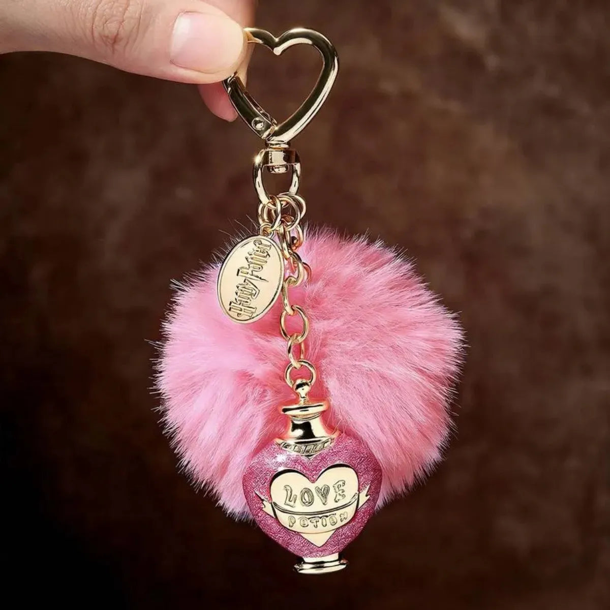 Chaveiro Harry Potter Love Potion Pompom Rosa Metal Dourado